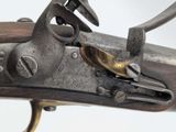 an old gun with a wooden handle on a white background
