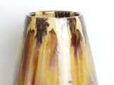 a close up of a vase on a table