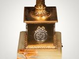an image of a gold and marble pedestal with a clock on top of it