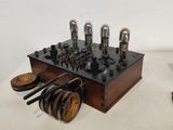 a small wooden box with a bunch of electrical equipment on top of it