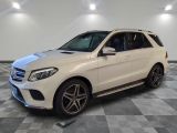 a white mercedes gle parked on a checkered floor