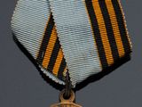 an image of a medal with a cross on the front of it