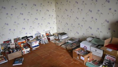a room that has a lot of books on the floor