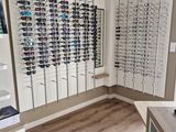 many glasses on display in a store with a lot of them