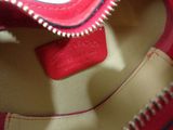 a close up of a red purse with a red handle