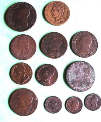 several different coins are arranged in a row on a table