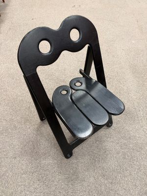 a black chair that has a pair of scissors on it