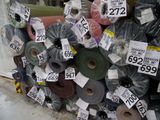 a pile of rolls of fabric with price tags on them
