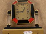 a clock that is sitting on a stand on the floor