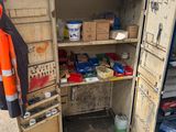 an open cabinet with many items inside of it