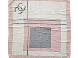 pink and grey plaid blanket with a monogram on the front