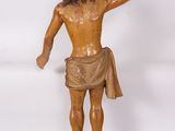 statue of a man with a halo on his head and a cross on his chest