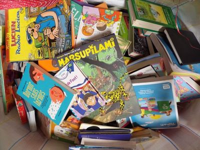 a pile of children ' s books sitting on the floor