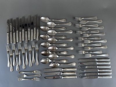 many forks and spoons laid out on the table