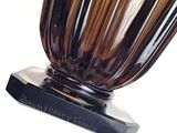 a glass vase that is sitting on a black base