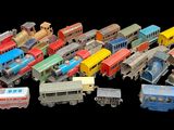 many different types of toy trains on a black background