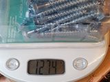 a digital scale with a bunch of screws on it
