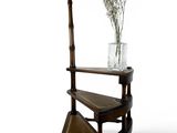 a vase with flowers sitting on top of a wooden shelf
