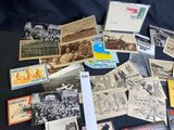 a lot of old postcards on a black table