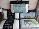 many pillows and blankets on display in a store