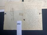 several old papers with handwriting on them are on display in a museum