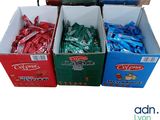 several boxes of candy sitting on top of each other on a table