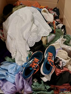 a box full of clothes and a pair of shoes