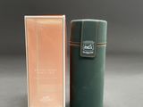 an image of a bottle of perfume sitting next to a box