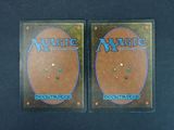 a pair of magic the gathering trading cards