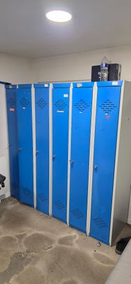 several blue lockers are lined up in a row in a room