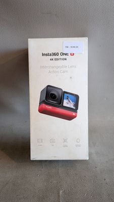 someone is taking a picture of a red camera in a box