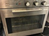 a silver oven that is sitting in the kitchen