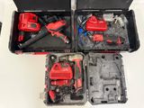 two red tools in a black case on a white table