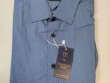 a close up of a blue shirt with a tag on it