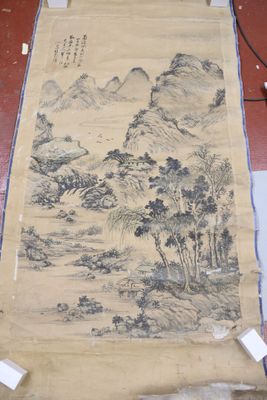 an old scroll with a painting of a mountain scene on it