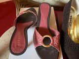 two pairs of shoes that are sitting on a box