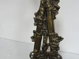 antique brass candle holder with two candles on top of it
