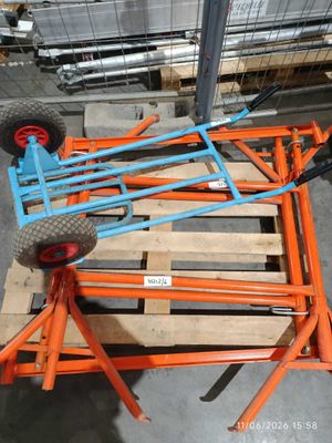 an orange and blue cart sitting on top of a pallet in a warehouse