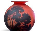 a red vase with a black and red design on it
