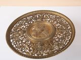 an image of a gold plate with a picture of a woman on it