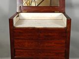 an old wooden chest with a mirror on top of it