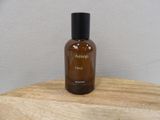 an image of a bottle of perfume sitting on top of a wooden table