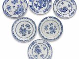 six blue and white plates with floral designs on them