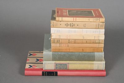 several books stacked on top of each other on a table