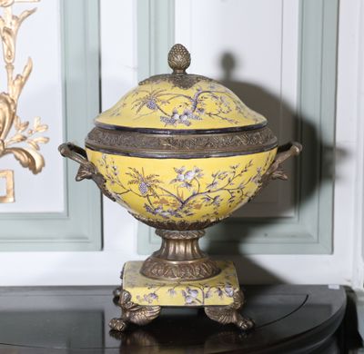 un bol jaune avec un couvercle posé sur une table