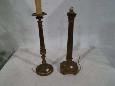 pair of antique brass candlesticks with candles on each side