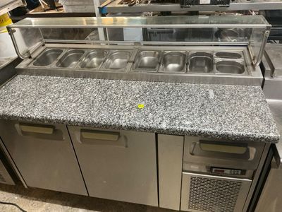 a counter with a bunch of food items on it