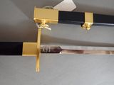 a black and gold sword on display on a table