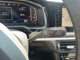 a car dashboard with a steering wheel and a digital display