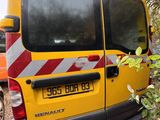 a yellow van that is parked next to a tree